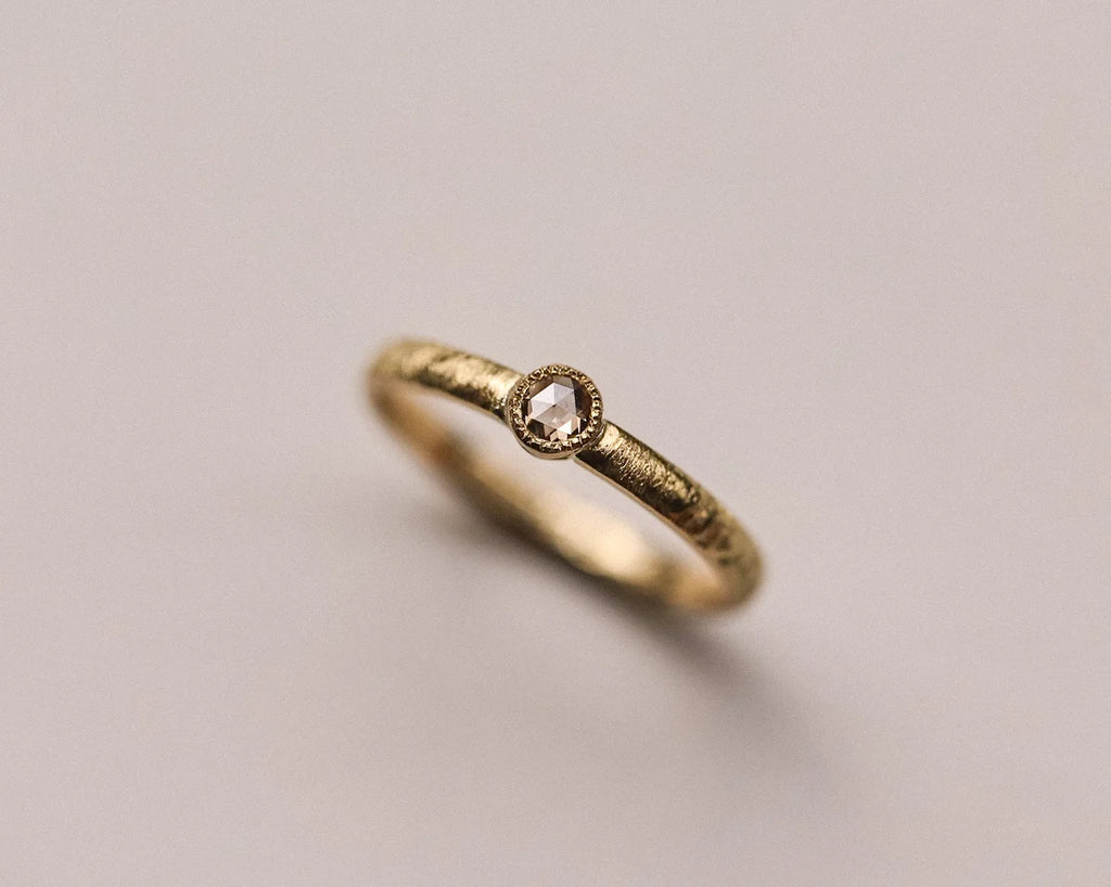 Angled close-up of handmade horn texture ring in 18ct yellow gold