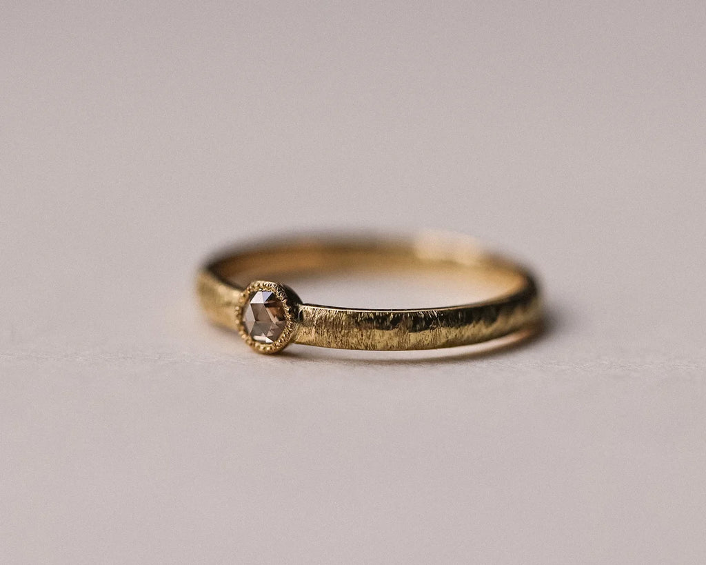 Front view of champagne rose-cut diamond ring with hand finished horn texture band