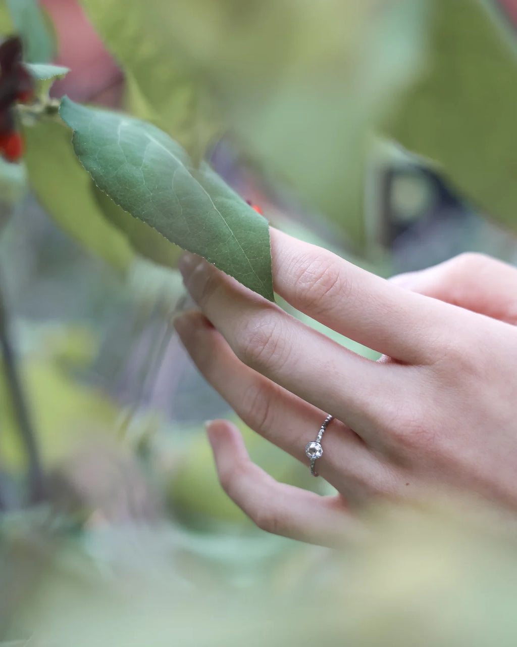 Lifestyle image of platinum rose-cut diamond ring worn on hand