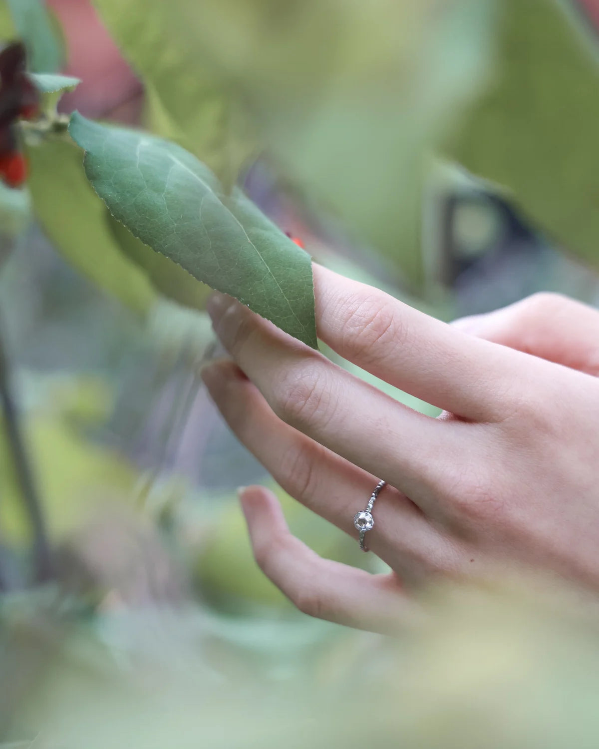 Lifestyle image of platinum rose-cut diamond ring worn on hand