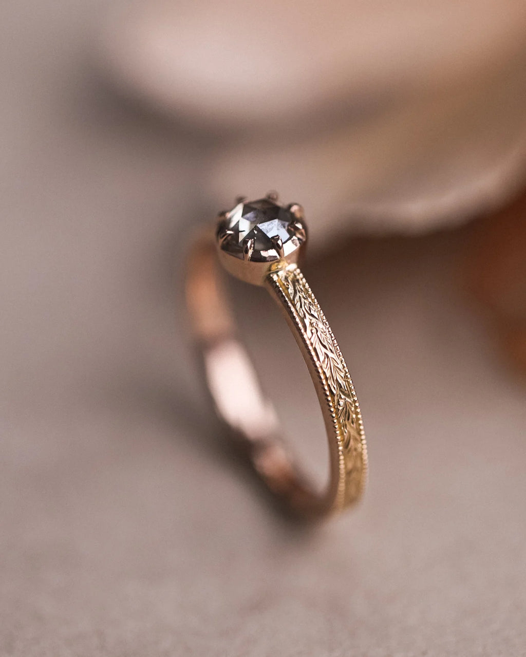 Side view of brown-grey rose-cut diamond ring with milled edge band