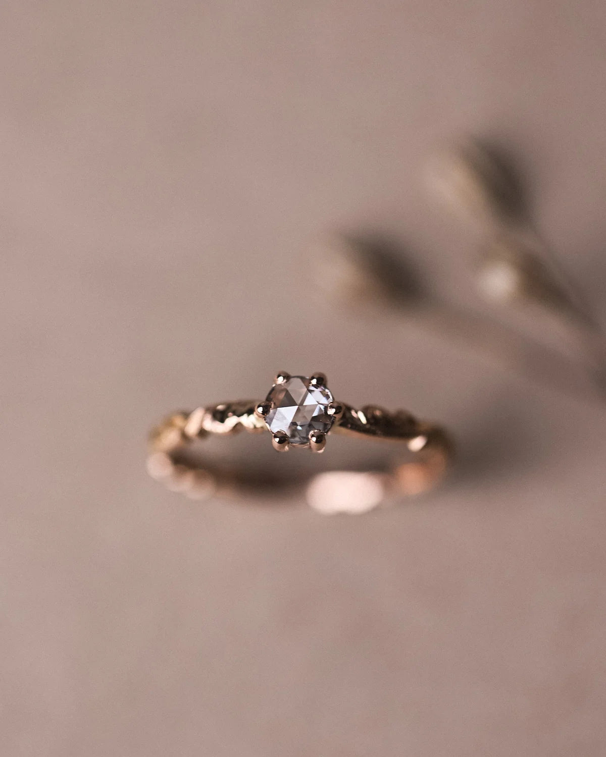 Editorial close-up of 18ct rose gold rose-cut diamond ring