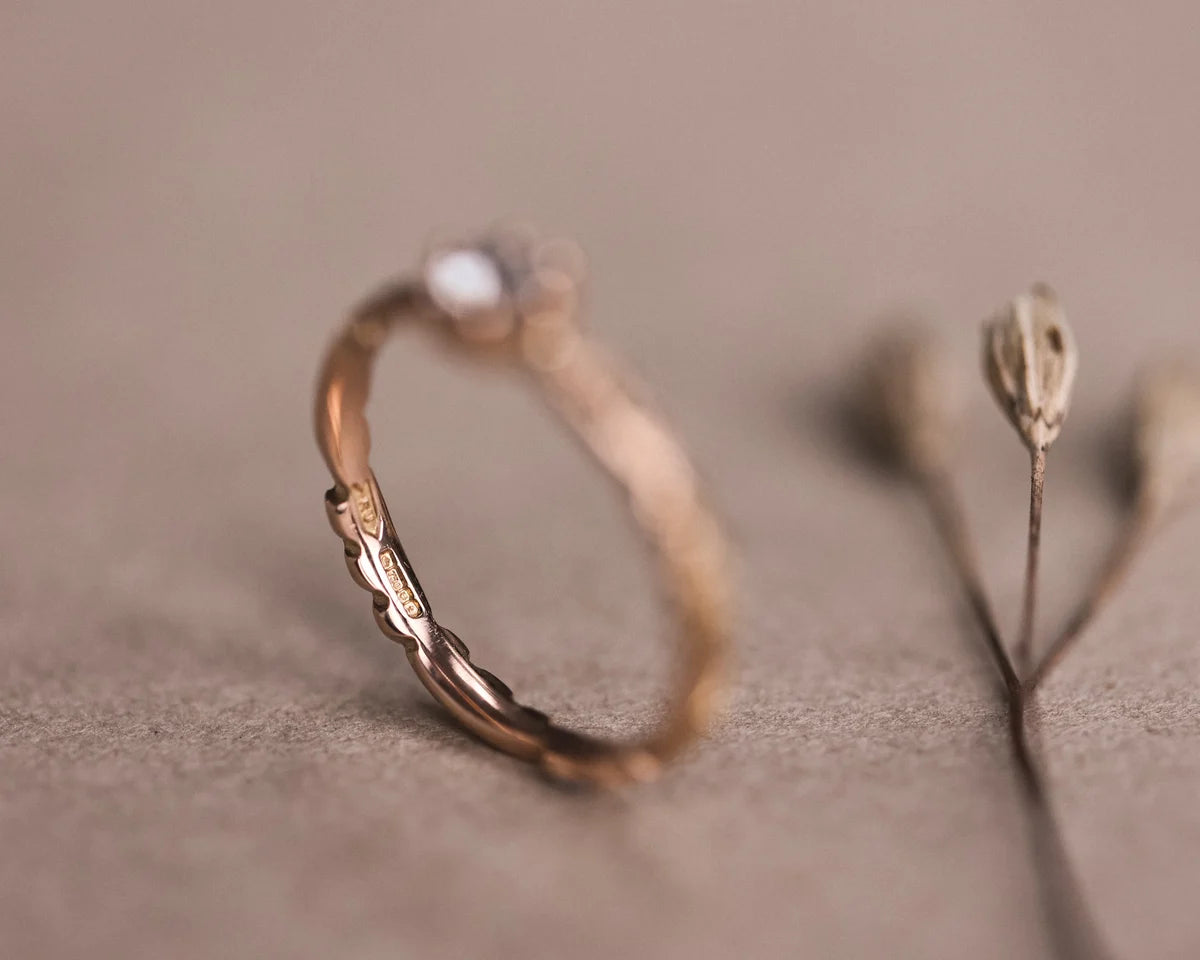 Side view of handmade floral carved ring with rose-cut diamond