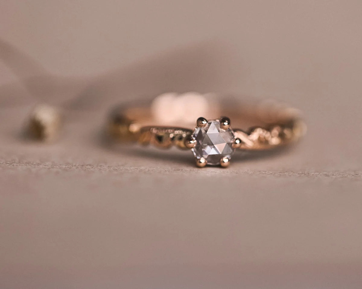 Front view of 18ct rose gold floral carved ring with rose-cut diamond