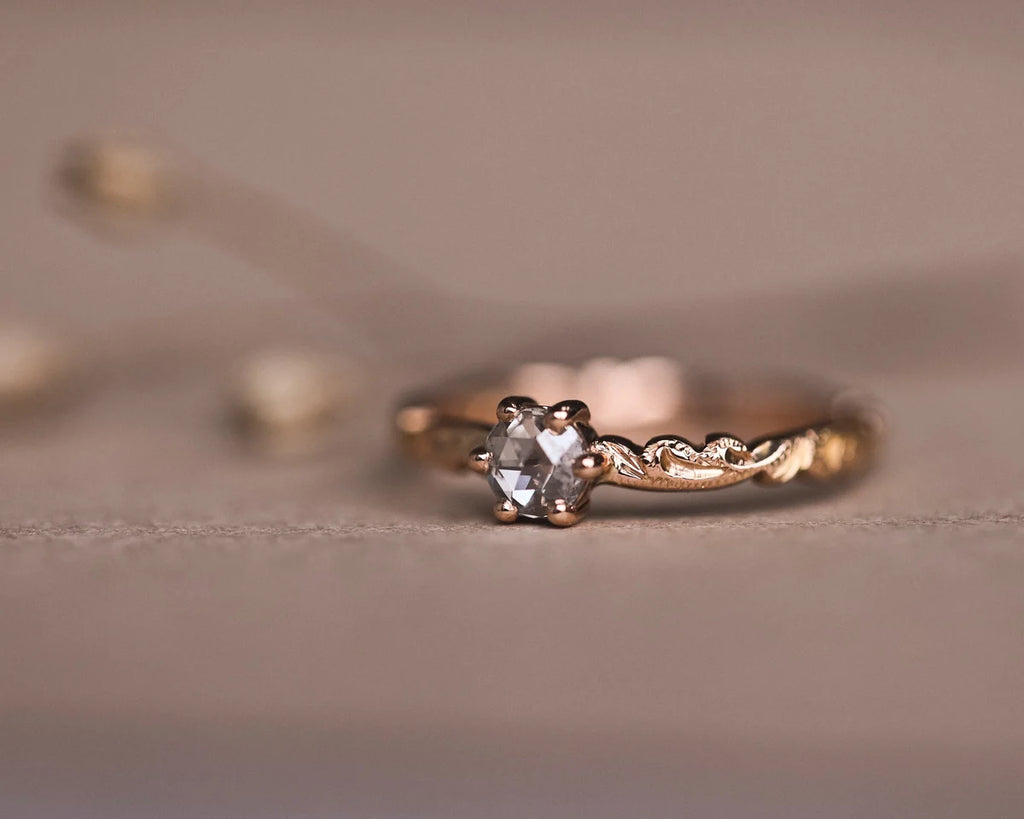 Low front view of rose-cut diamond ring with floral carved band