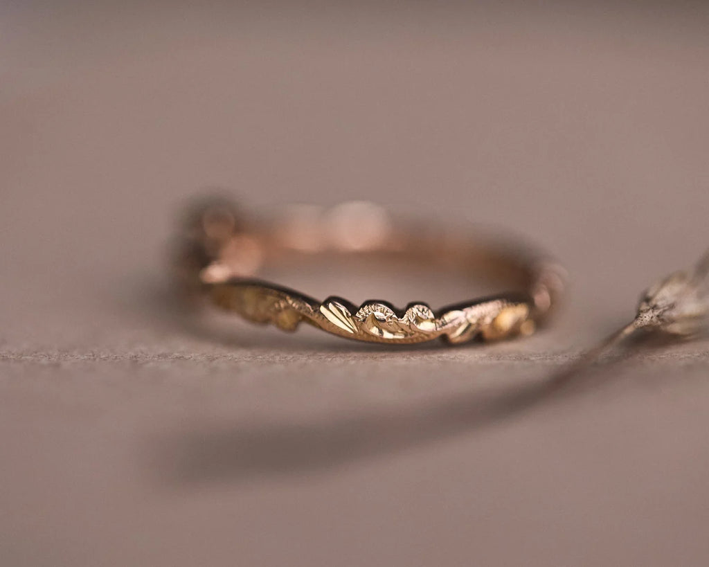 Detail of floral carving on 18ct rose gold diamond ring