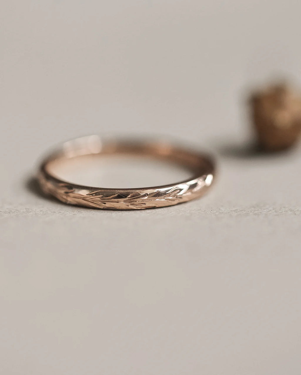 Front view of 18ct rose gold olive leaf engraved wedding ring