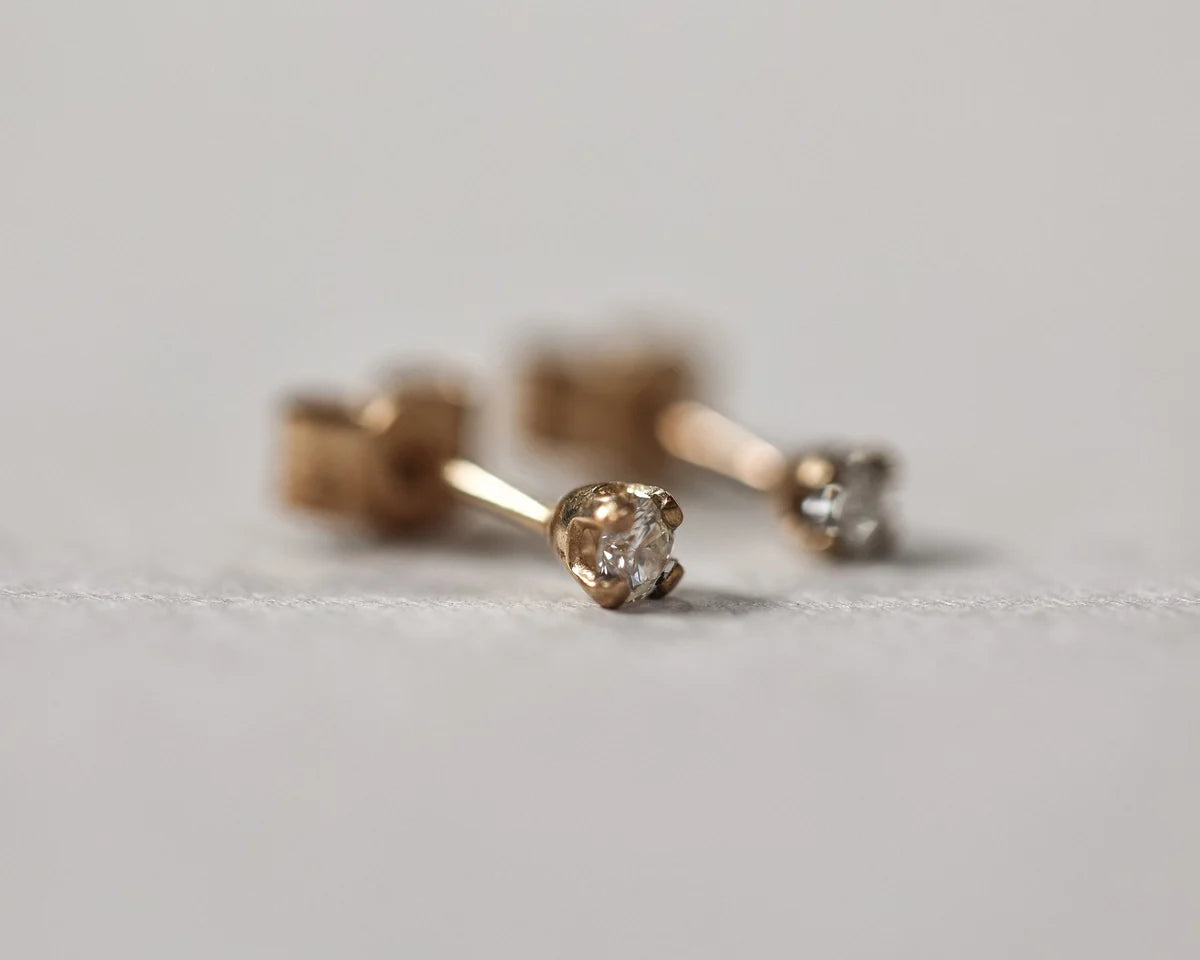 profile view gold diamond studs minimal design