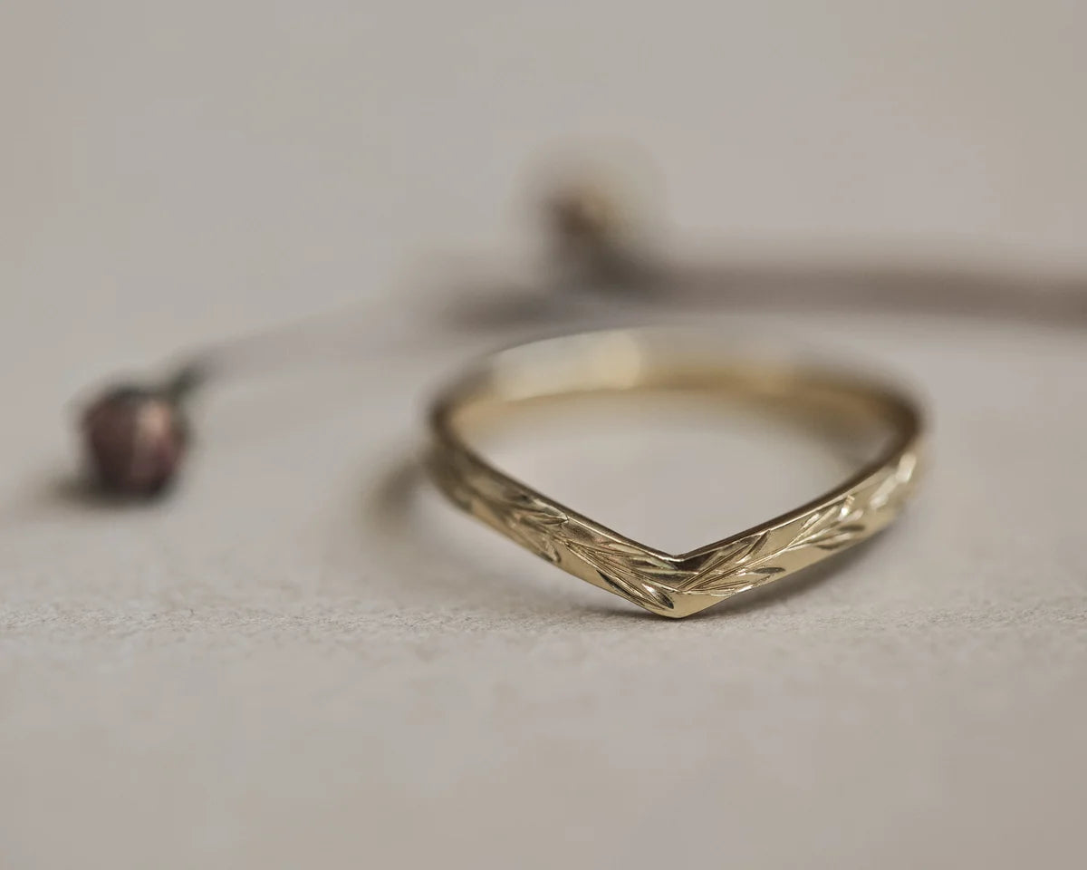 Front view of 2mm yellow gold wishbone ring with olive leaf engraving