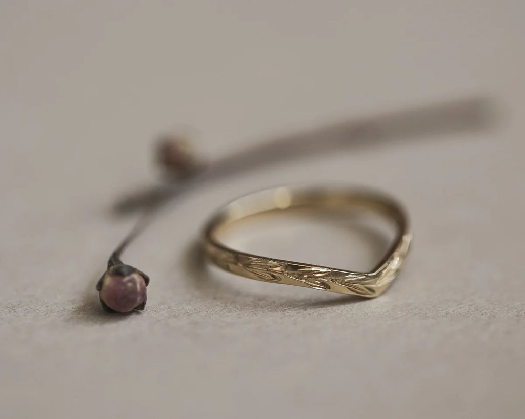 Low front view of handmade olive leaf wishbone ring in yellow gold