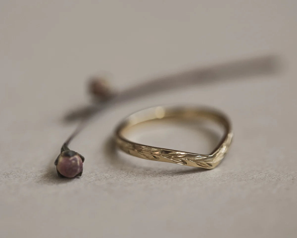 Low front view of handmade olive leaf wishbone ring in yellow gold