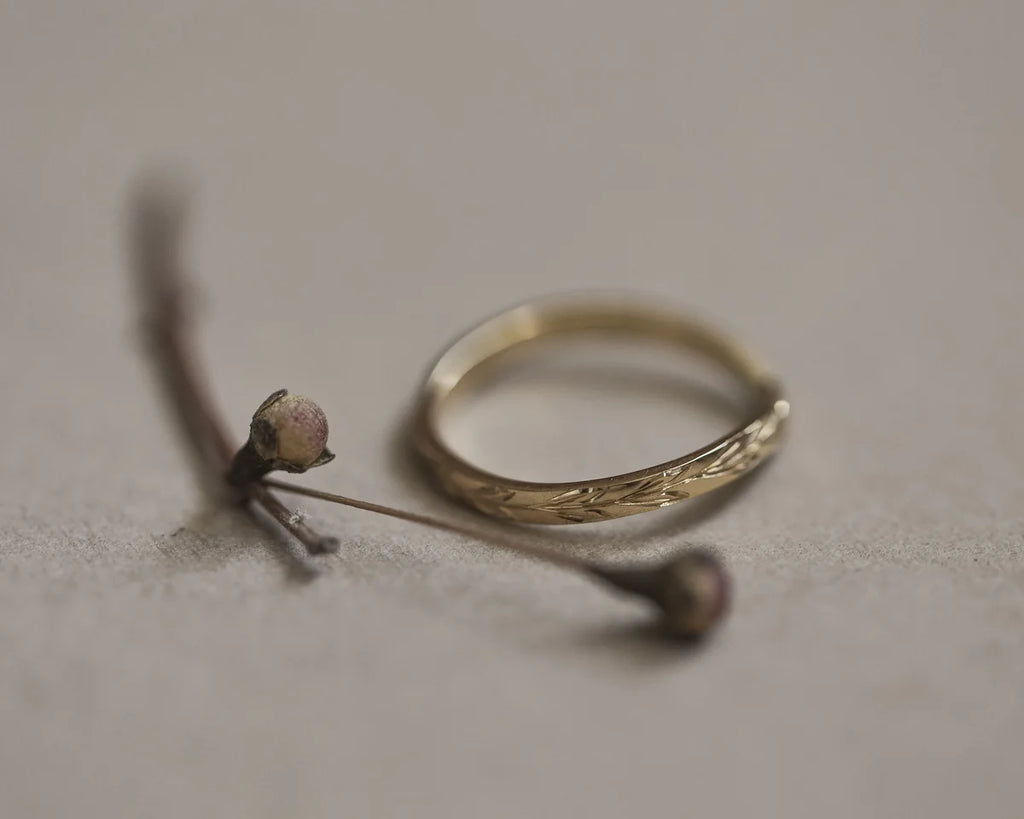 Side profile of handmade olive leaf engraved wishbone ring