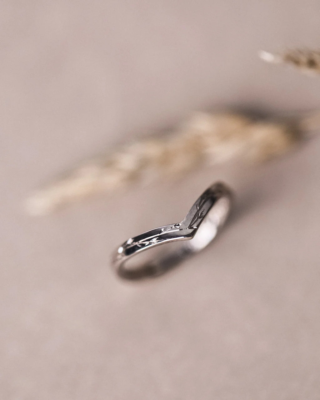 Vertical view of 18ct white gold pressed flower wishbone ring