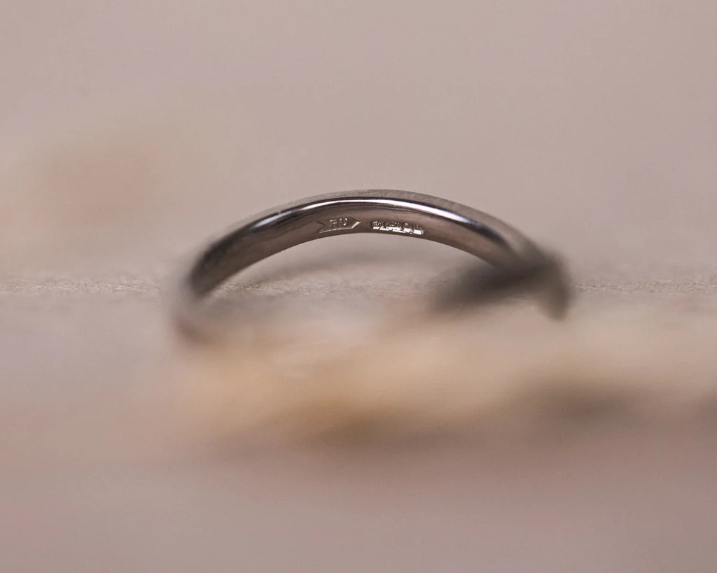 Soft close-up of handmade 18ct white gold wishbone ring