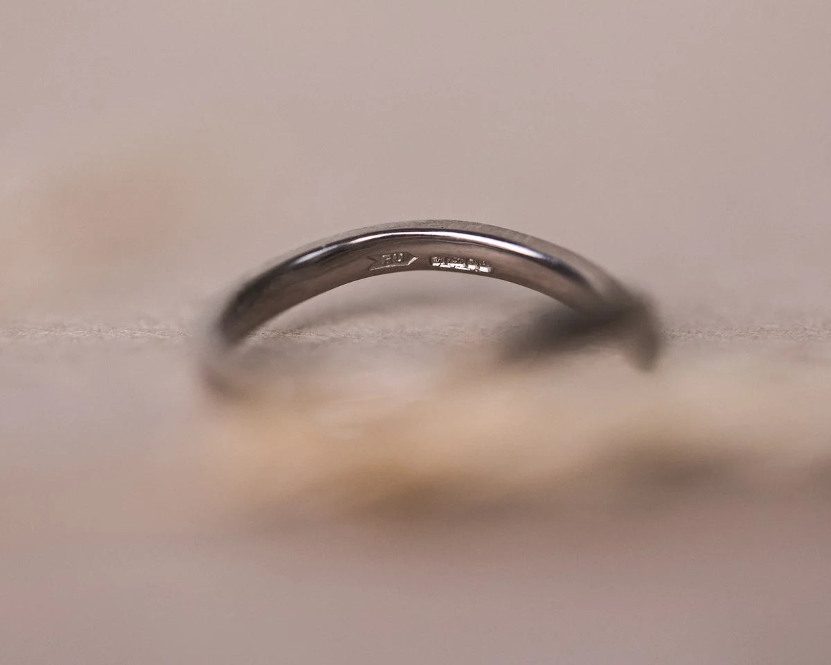 Soft close-up of handmade 18ct white gold wishbone ring