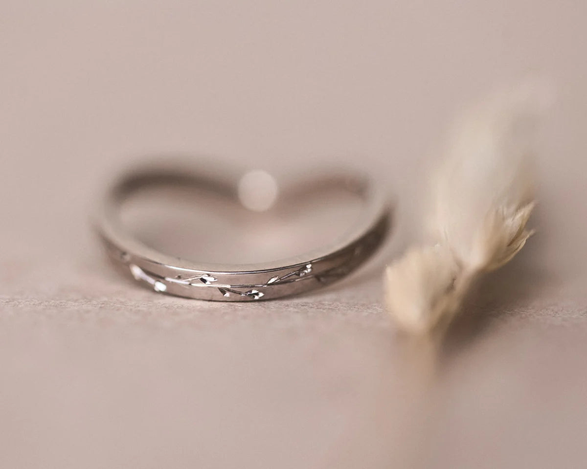 Low front view of white gold pressed flower wishbone ring