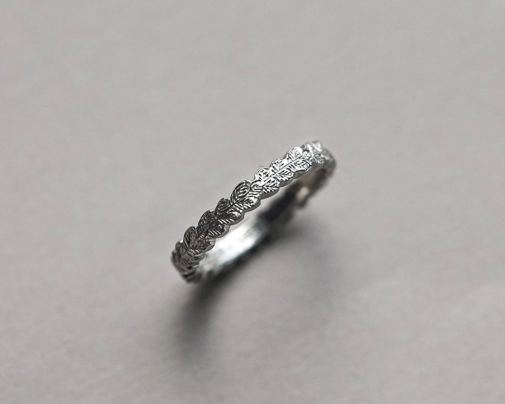 close up oak leaf engraving platinum band fine carved detail