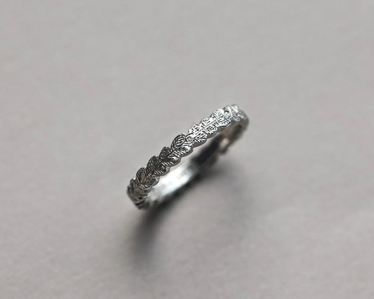 close up oak leaf engraving platinum band fine carved detail