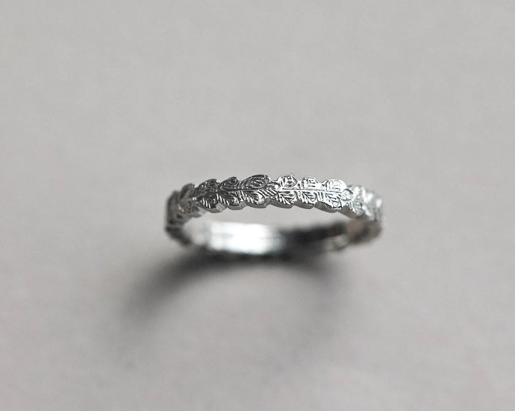 hand carved oak leaf detail platinum ring surface