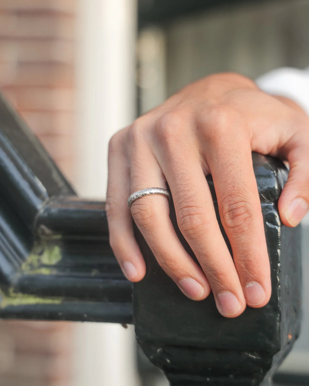 Hand with a ring on a stair handle