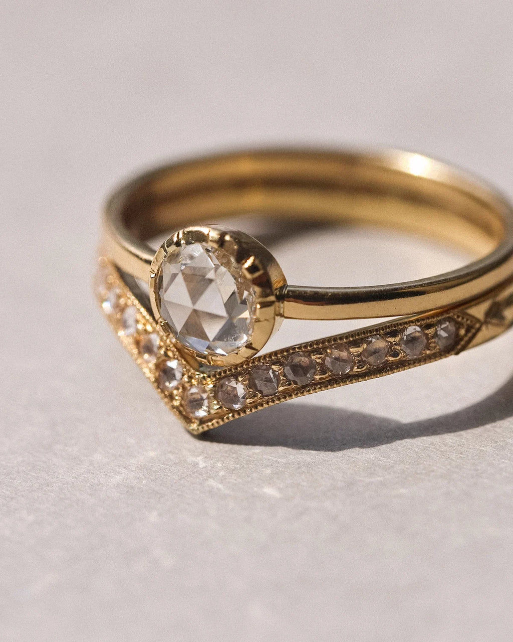 Rose-cut diamond solitaire ring paired with pavé wishbone wedding band
