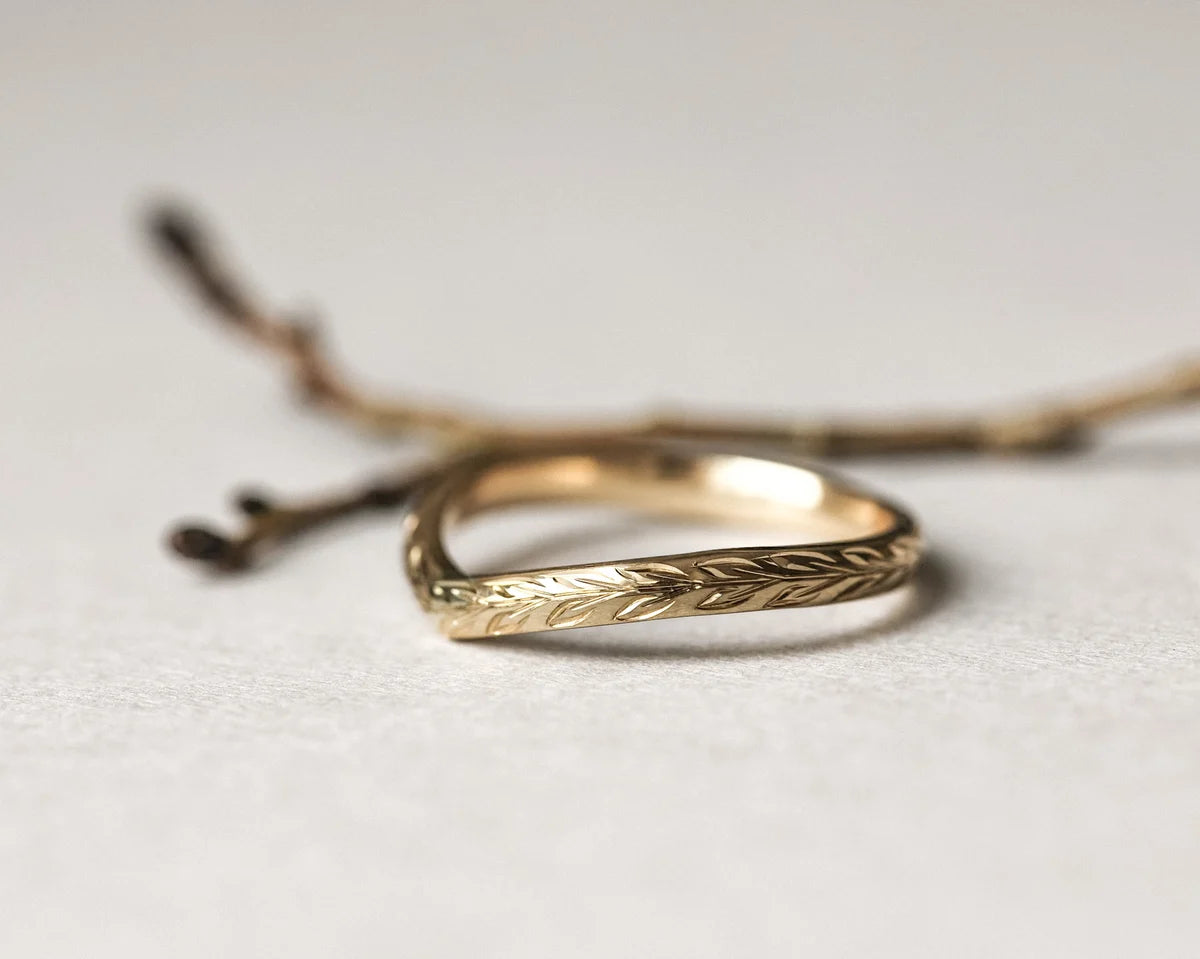 close up olive leaf engraving on 2mm gold wishbone ring