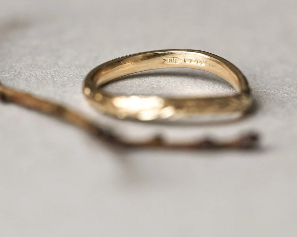 Gold ring on a textured gray surface
