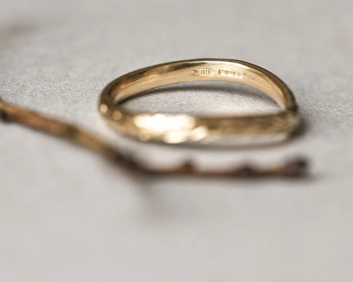 Gold ring on a textured gray surface