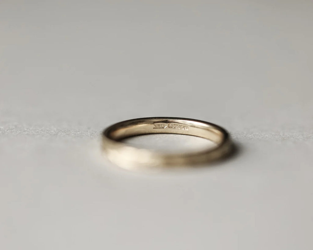 Gold ring on a light gray background
