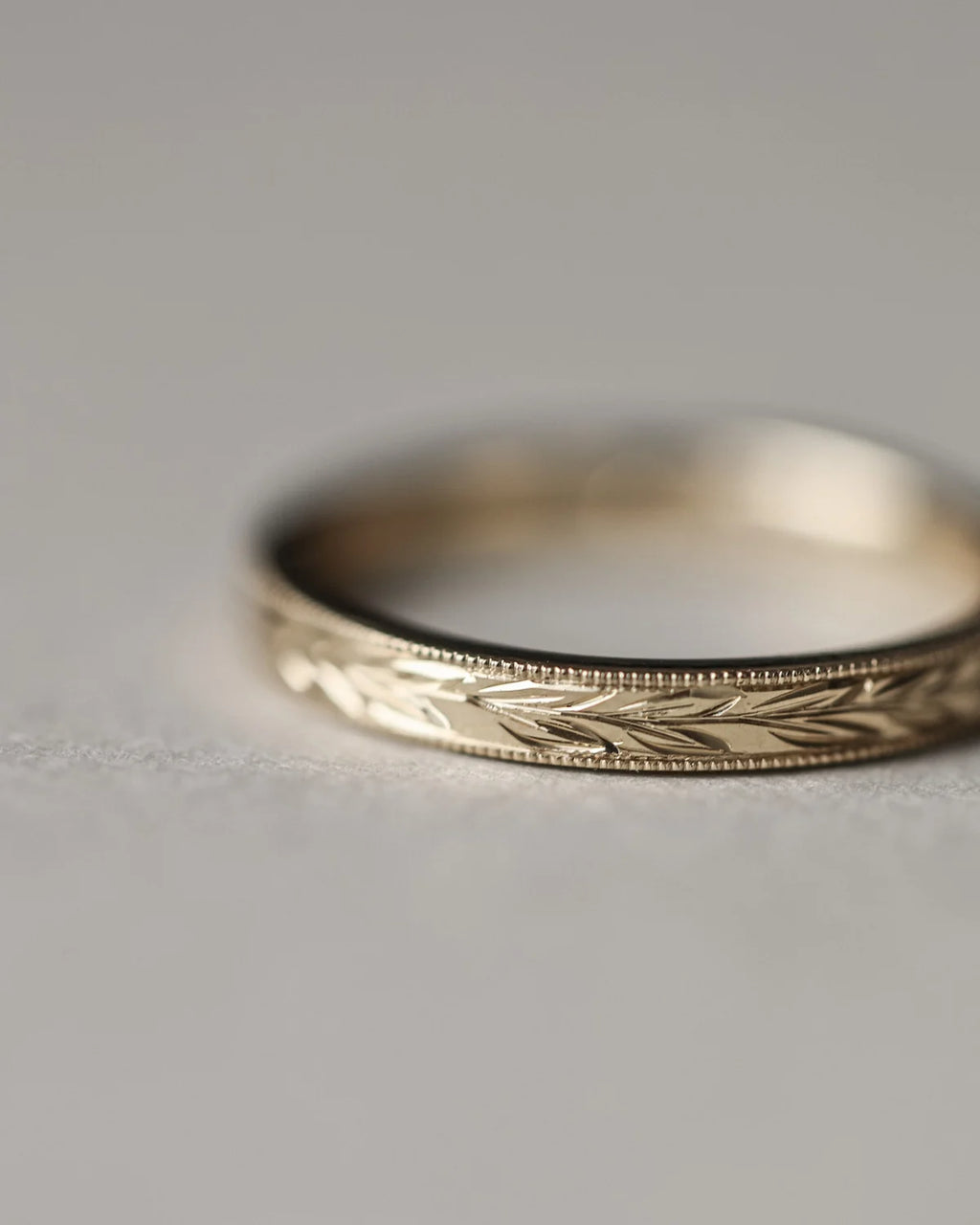 close up olive leaf engraving on 2.5mm gold wedding ring