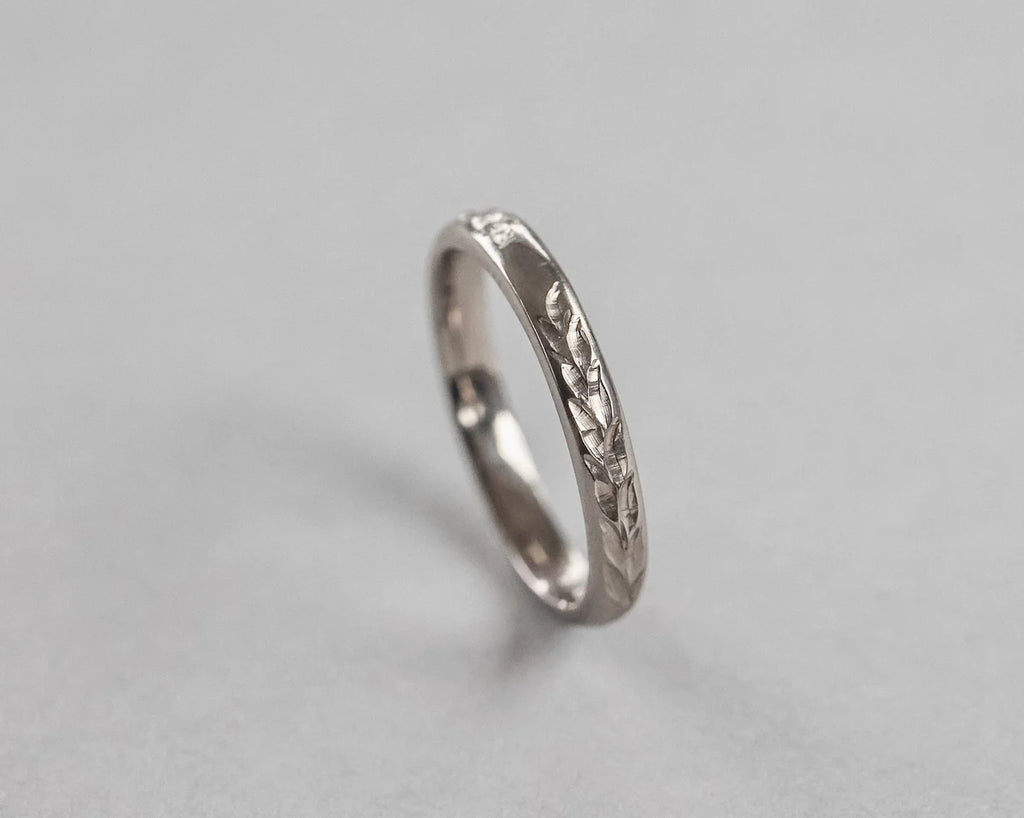 Vertical view of handmade Barleycorn engraved wedding ring