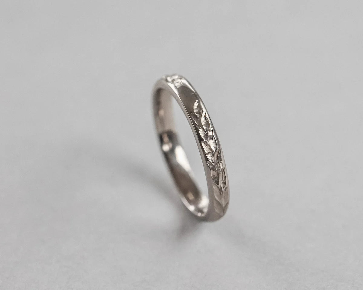 Vertical view of handmade Barleycorn engraved wedding ring