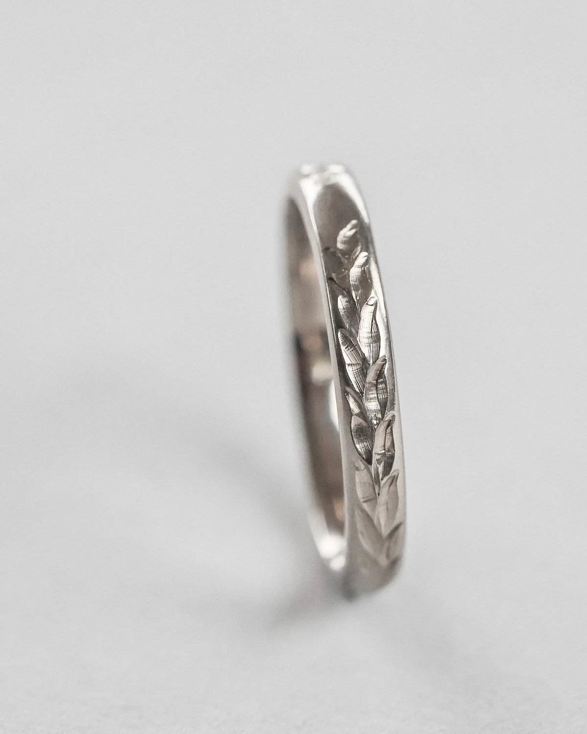 Side profile of Barleycorn engraved wedding ring in white gold