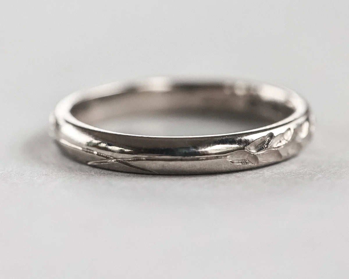 Low front view of hand engraved Barleycorn wedding ring