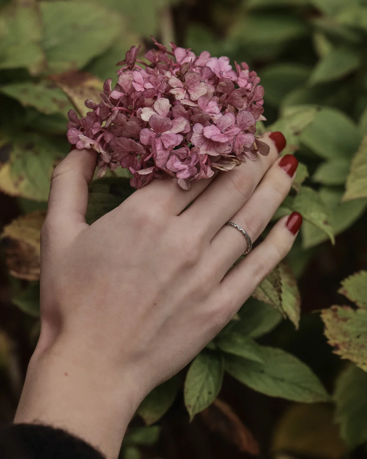 platinum wedding ring worn on hand laurel engraved band