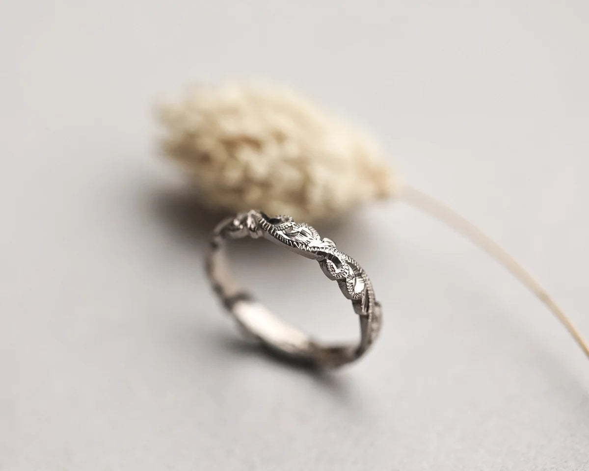 close up floral carving detail on white gold ring 3mm band
