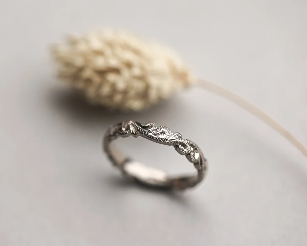 close up floral carving detail on white gold ring 3mm band