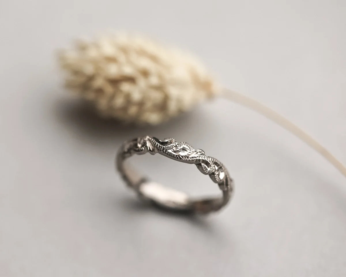 close up floral carving detail on white gold ring 3mm band