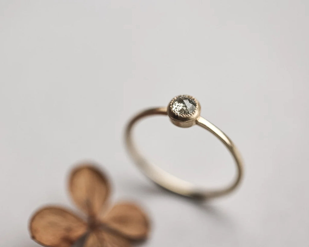 Close-up of yellow-grey rose-cut diamond solitaire ring