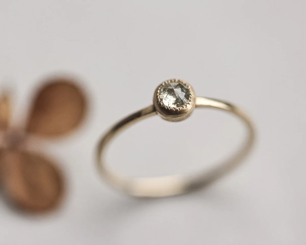 Close-up of yellow-grey rose-cut diamond solitaire ring