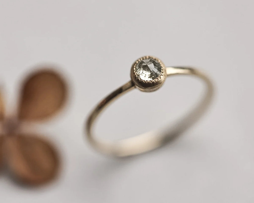 Close-up of yellow-grey rose-cut diamond solitaire ring