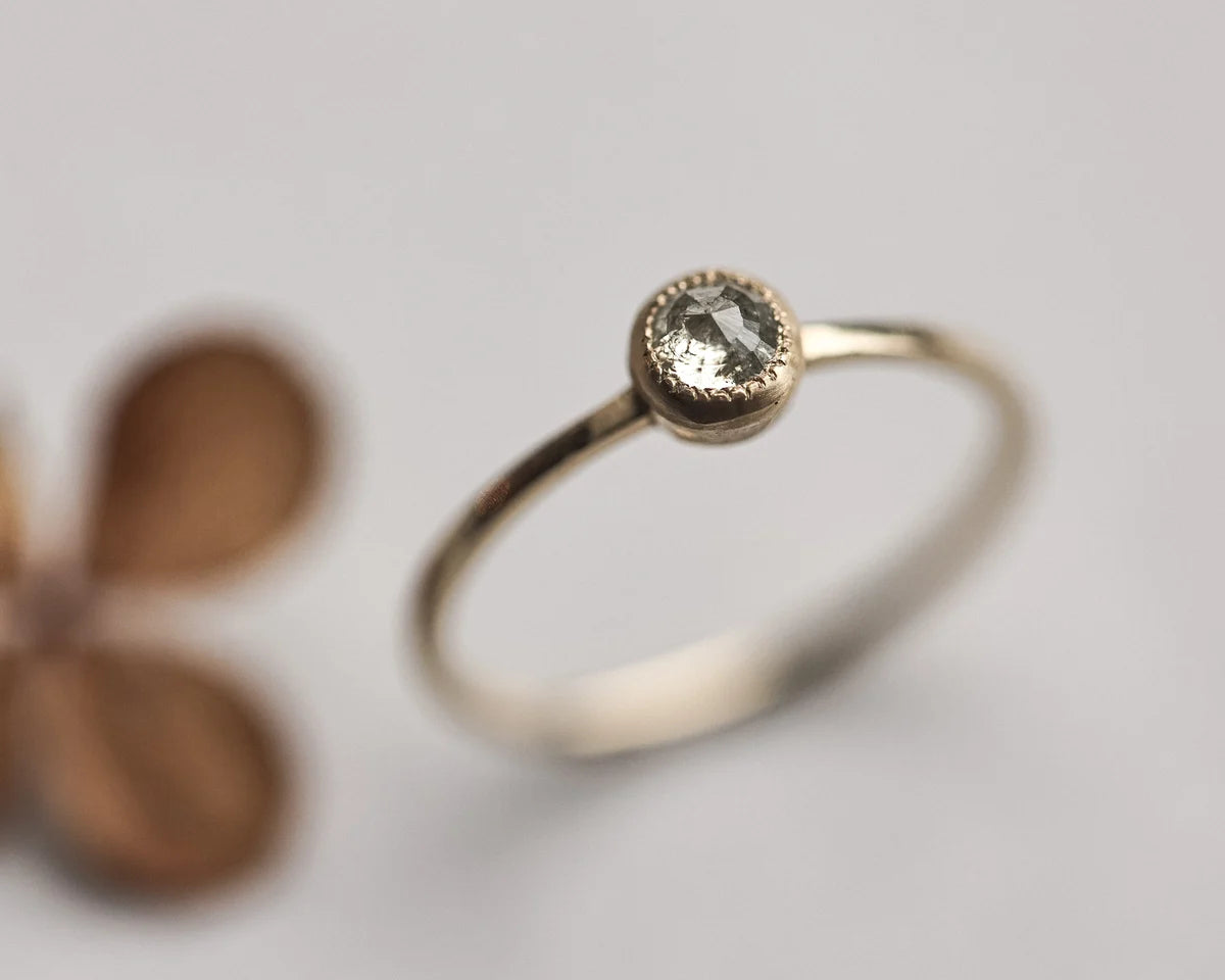 Close-up of yellow-grey rose-cut diamond solitaire ring