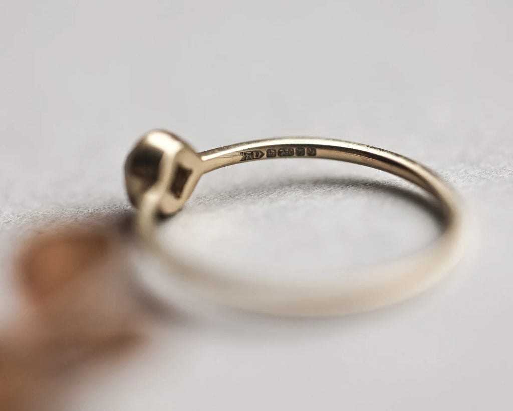 Side view of yellow-grey rose-cut diamond ring with slim band