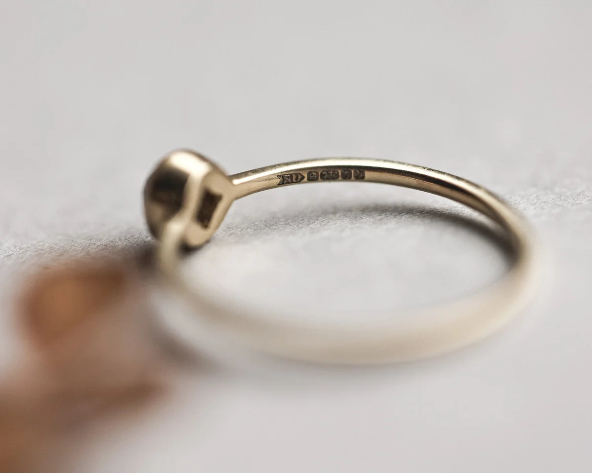 Side view of yellow-grey rose-cut diamond ring with slim band