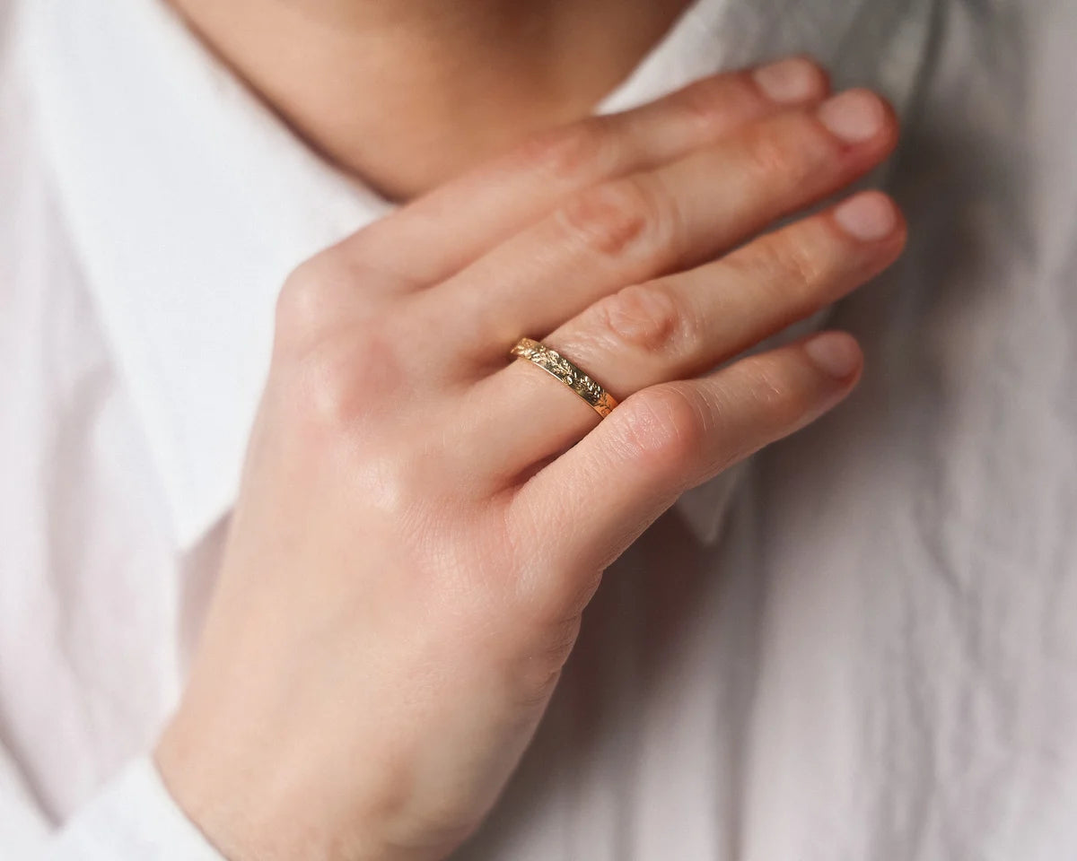 gold wedding ring worn on hand engraved band 18ct