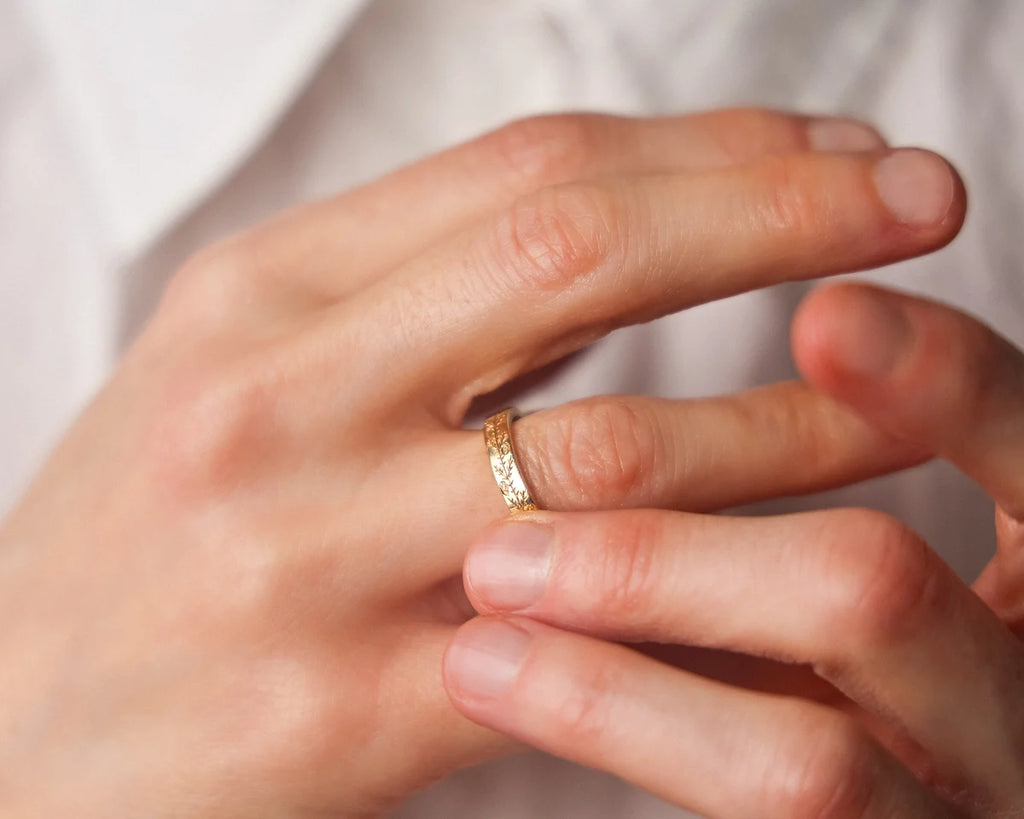 gold wedding ring worn on hand engraved band 18ct