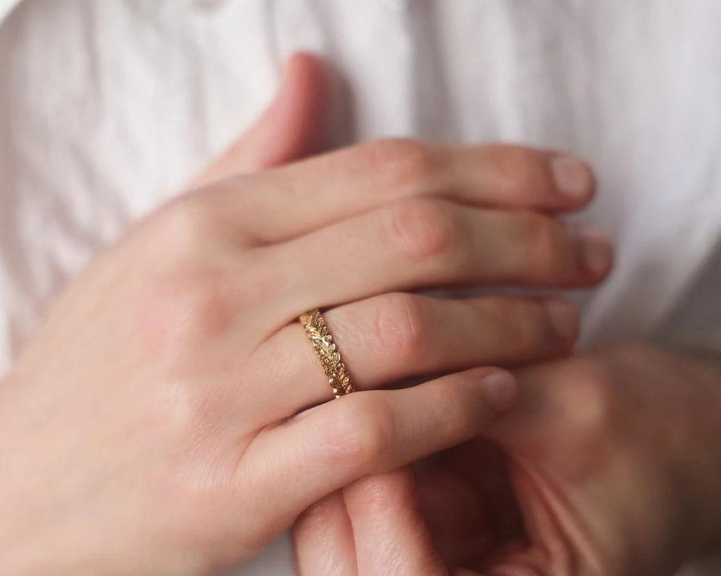 wide gold wedding ring worn on hand 4mm oak leaf band