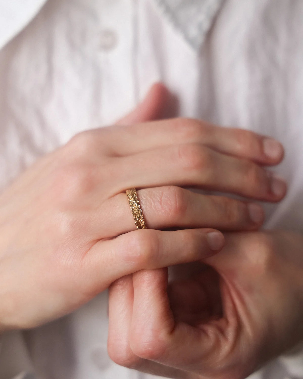 carved gold ring worn on hand organic leaf pattern