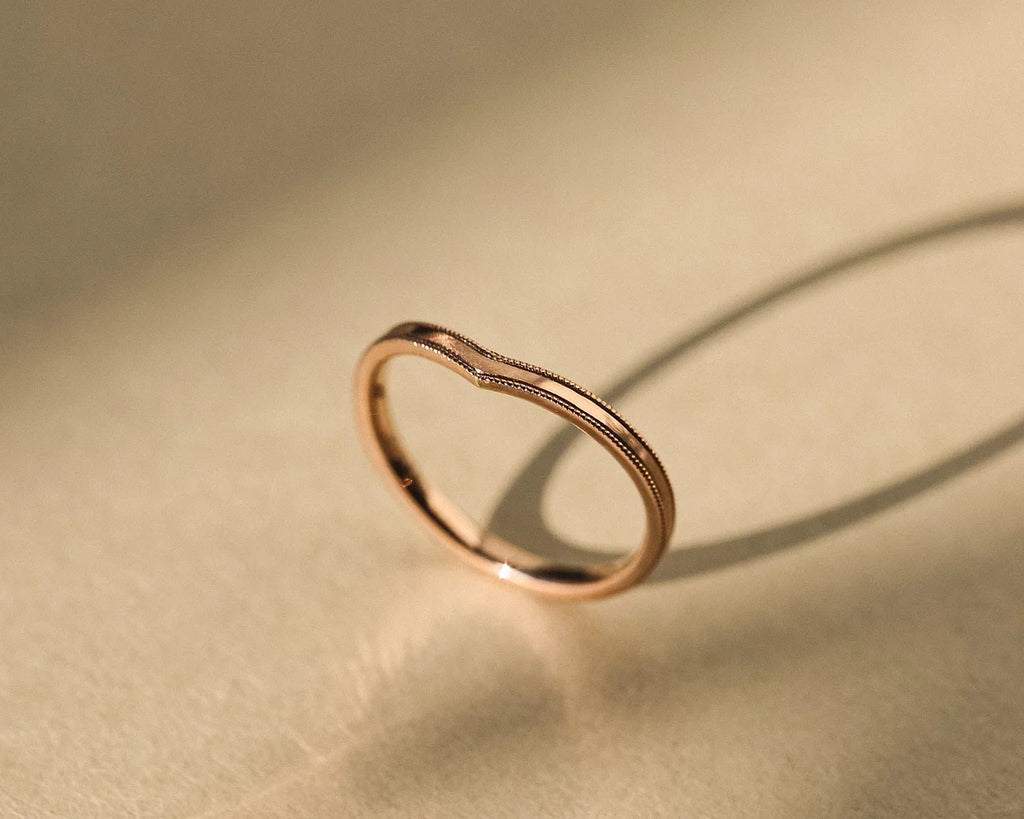 Side view of rose gold V-shaped wishbone wedding ring