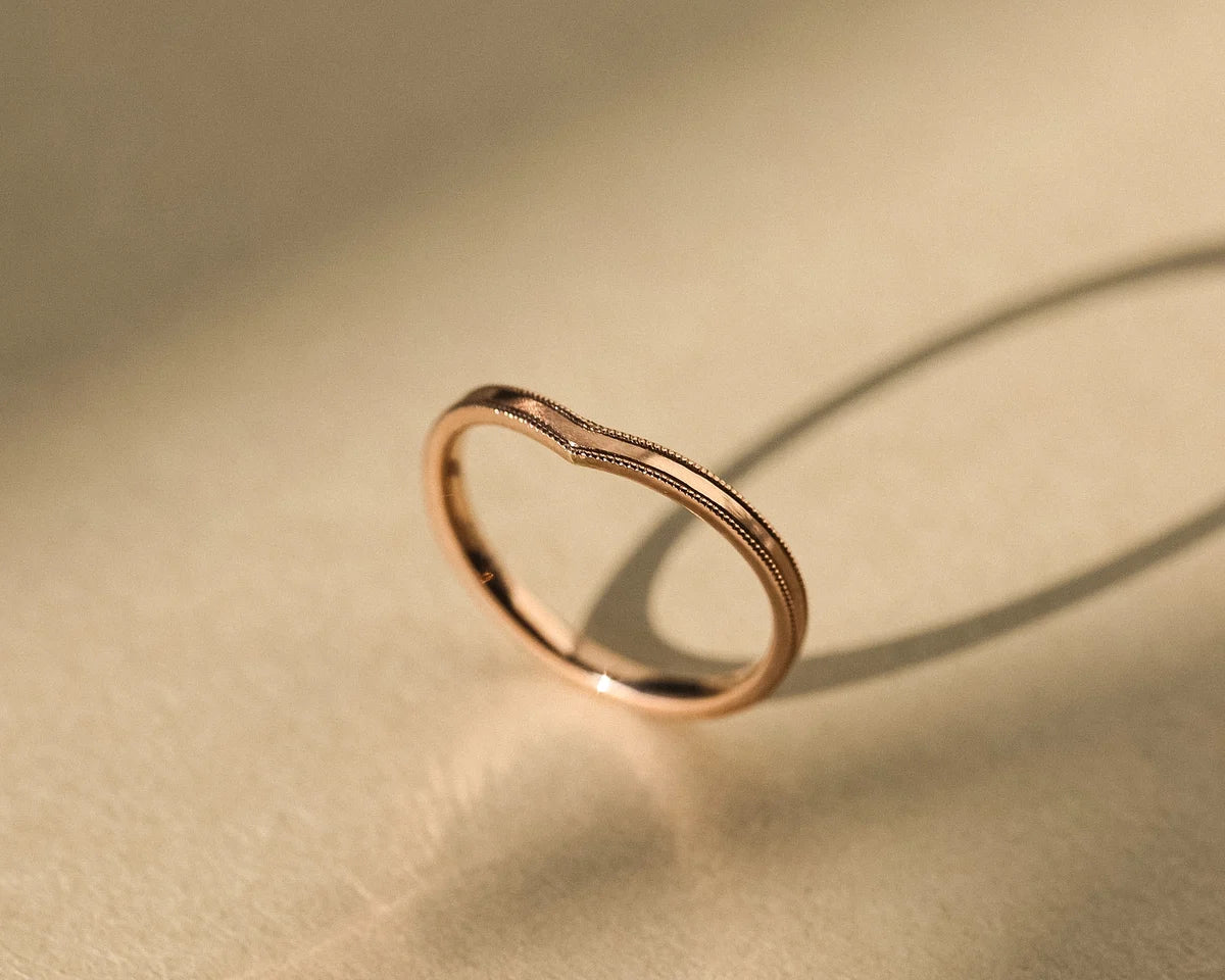 Side view of rose gold V-shaped wishbone wedding ring